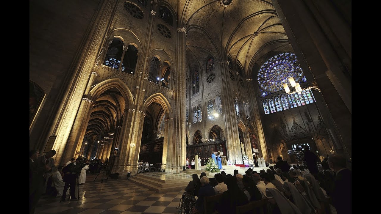 French president vows to bring back charred Notre Dame cathedral