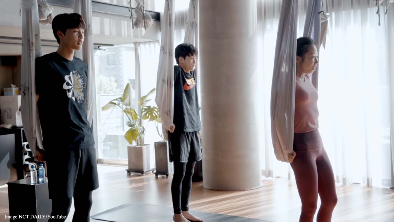 K-pop stars Johnny Suh and Mark Lee of NCT 127 try out aerial yoga